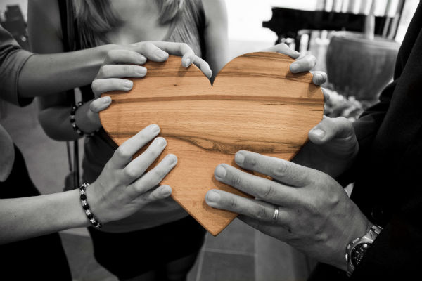 Hands on a wooden heart
