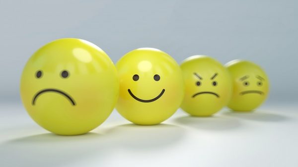 yellow balls with faces in different moods
