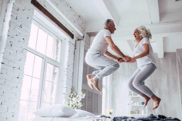 Happy-Couple-jumping-on-bed blog for the positive psychology people