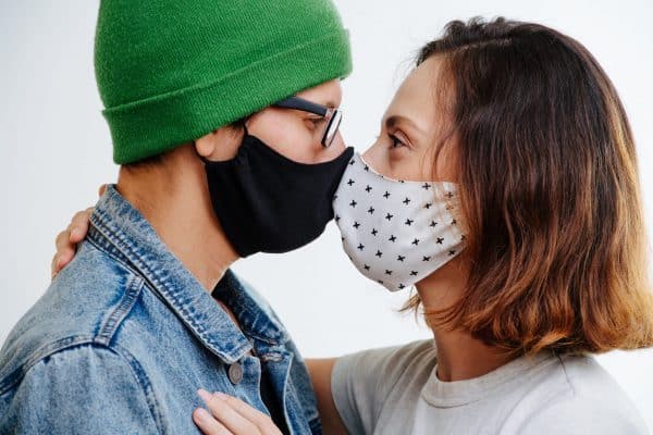 couple kissing with covid masks blog aboutl lockdown relationships the positive psychology people