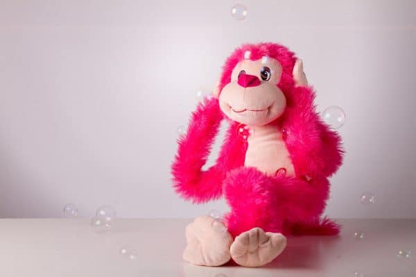 toy monkey with hands over ears