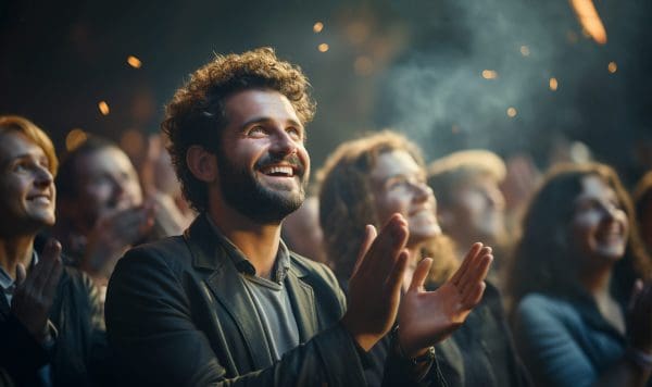 Happy audience applauding at a show or business seminar,theater performance listening and clapping at conference and presentation.Group of supporters,fans cheering excited applauding closeup
